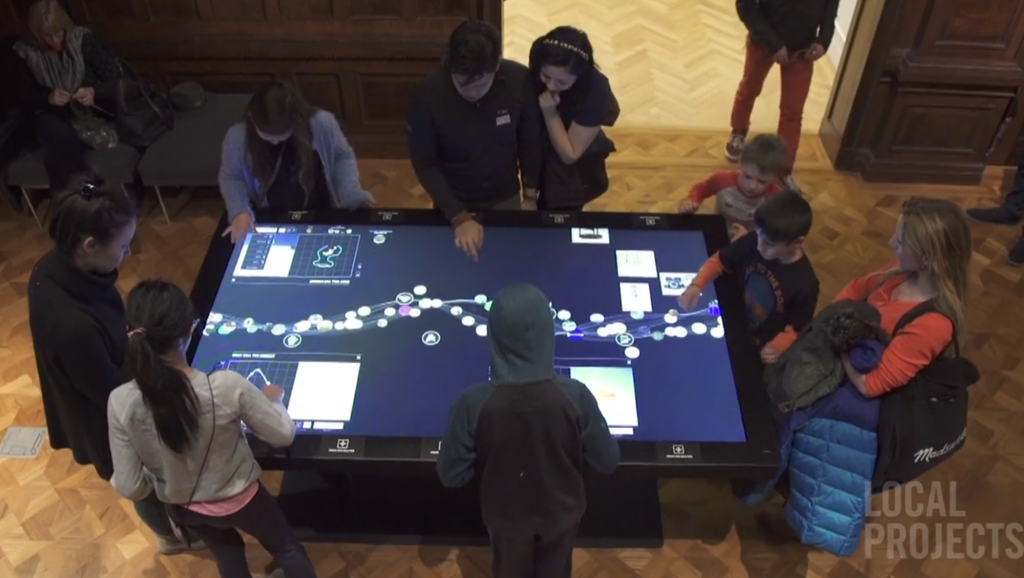 Still frame from video produced by Local         Projects showing social use of interactive tables.